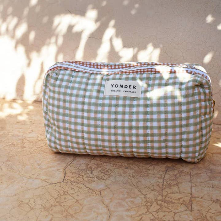 Checkered pouch with 'Yonder' label on a textured surface