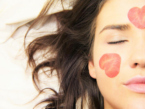 Woman face with strawberry heart shapes patches