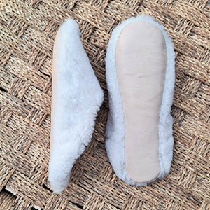 Two pairs of slippers on a textured mat