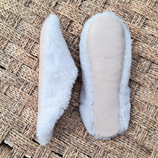 Two pairs of slippers on a textured mat