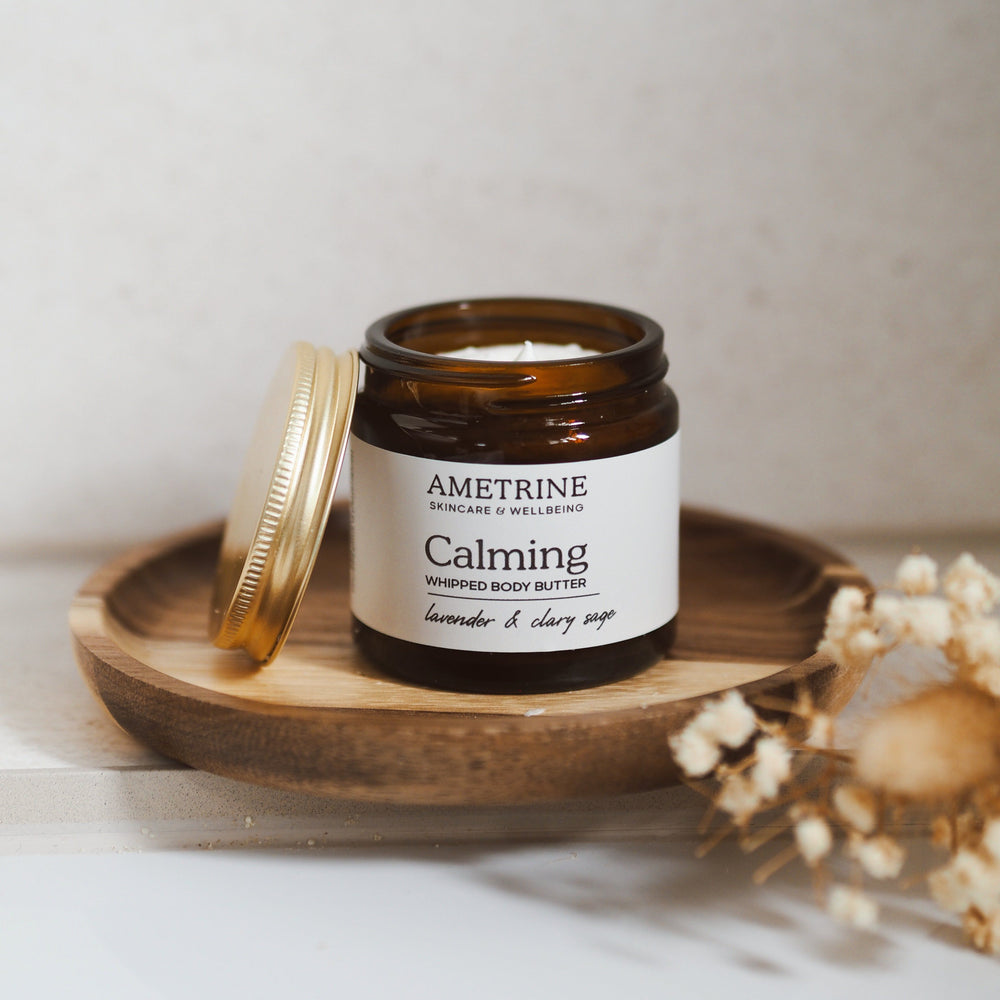 Ametrine Calming whipped body butter in amber jar on wooden dish, lavender and clary sage scent for relaxing evening care.