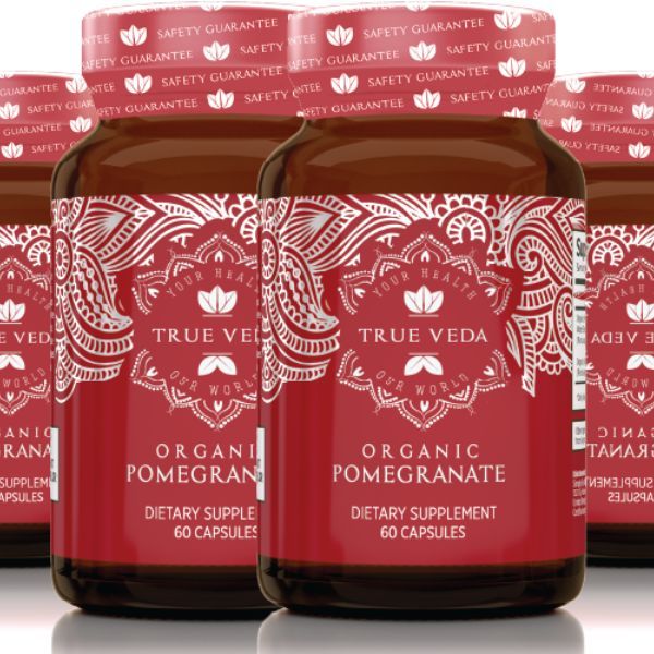 True Veda Organic Pomegranate supplement bottles grouped together with red labels; 60 capsules per bottle in organic vitamins range.

