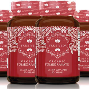 True Veda Organic Pomegranate supplement bottles grouped together with red labels; 60 capsules per bottle in organic vitamins range.

